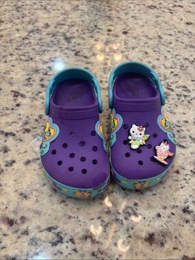 CROCS Purple Clog Sandals with Teal Trim and Character Charms